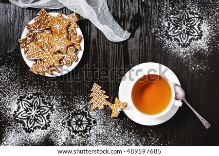 Christmas gingerbread and cup of tea with snowflakes decorations