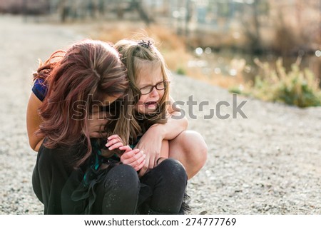 Mother consoling her hurt daughter at a park in Reno, Nevada, USA.