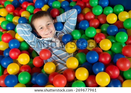 stock-photo-a-boy-in-the-playing-room-with-many-little-colored-balls-close-portrait-269677961.jpg