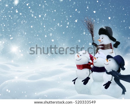 Merry Christmas and happy New Year greeting card with copy-space.Many snowmen standing in winter Christmas landscape.Winter background
