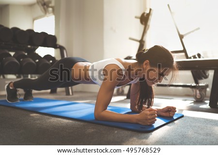 Asian woman exercising in the gym, she was pretending to "plank"