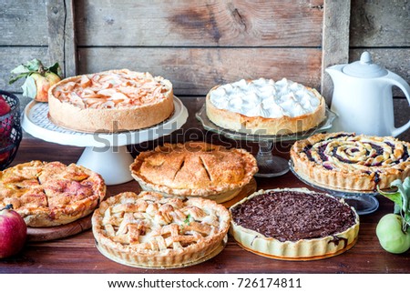 Assorted Homemade Rustic American Style Apple Berry Chocolate And Lemon Meringue Pies Assorted Homemade Rustic American Style Apple Berry Chocolate And Lemon Meringue Pies