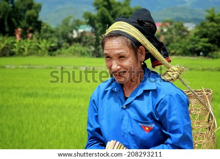 Dien Bien Phu, Vietnam July 31, 2014: A woman Lu ethnic cargo by force of the head.