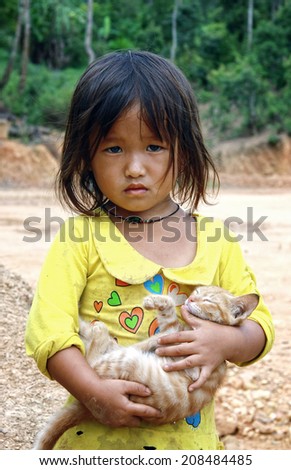 Dien Bien Phu, Dien Bien, Vietnam August 1, 2014: A unidentified Hmong child holding a cat.