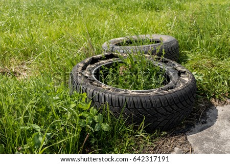 stock-photo-two-old-damaged-tires-lie-on