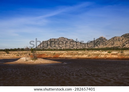 Mountainous Coastline at Ca Na, in the foreground, an artificial lake for salt extraction, Ninh Thuan, Vietnam