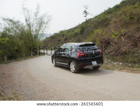 Bac Giang, Viet Nam - March 17, 2015: A SUV Peugeot 3008 car running on the road in Vietnam