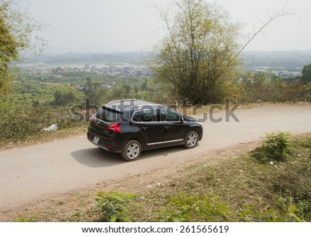 Bac Giang, Viet Nam - March 17, 2015: A SUV Peugeot 3008 car running on the road in Vietnam