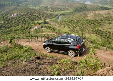 Bac Giang, Viet Nam - March 17, 2015: A SUV Peugeot 3008 car running on the mountain road in Vietnam
