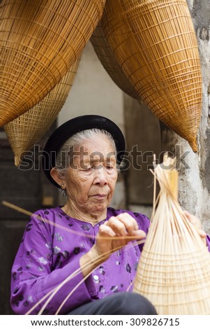 Hungyen, Vietnam - July 26, 2015:Unidentified woman was weaving bamboo in HungYen, Vietnam. Weaving this tools that used to catch fish is traditional occupation in Hung Yen province.