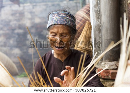 Hungyen, Vietnam - July 26, 2015:Unidentified woman was weaving bamboo in HungYen, Vietnam. Weaving this tools that used to catch fish is traditional occupation in Hung Yen province.
