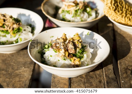 Traditional Vietnamese chicken soup (Pho ga) on a wooden background