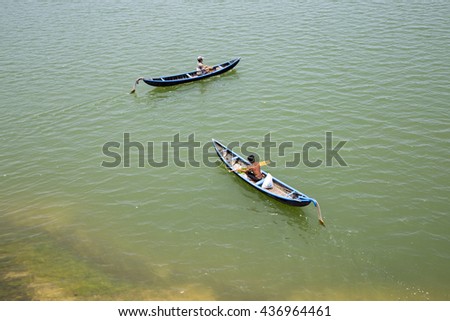 Phu Yen, Viet Nam - March 31, 2016: Young man on a wooden boat : rowing fisherman in Vietnam