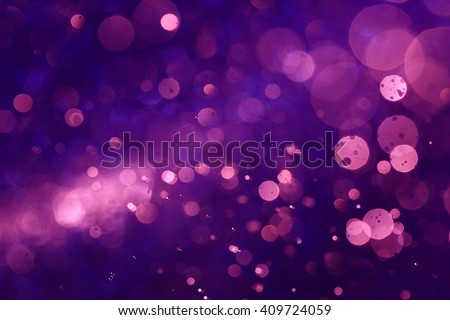 Purple bokeh abstract background caused by spray water.