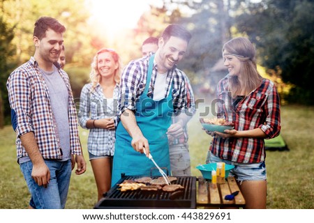 Friends camping and having a barbecue in nature
