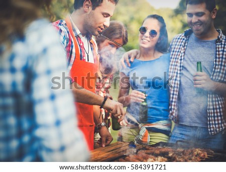 Friends having a barbecue party in nature while having a blast