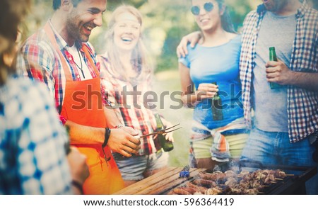 Friends having a barbecue party in nature while having a blast