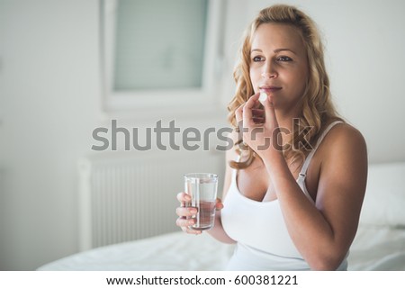 Pregnant Woman Taking Pill Against Heartburn Stock Photo ...