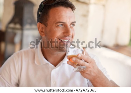 https://thumb7.shutterstock.com/display_pic_with_logo/2457938/472472065/stock-photo-rich-man-drinks-whiskey-cognac-in-summer-elite-club-male-model-with-glass-of-alcoholic-brandy-472472065.jpg