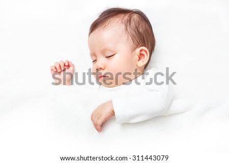 Newborn sleeping on the white bed (isolated on white background)