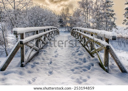 Snowy, wooden bridge in a winter day. Stare Juchy, Poland.