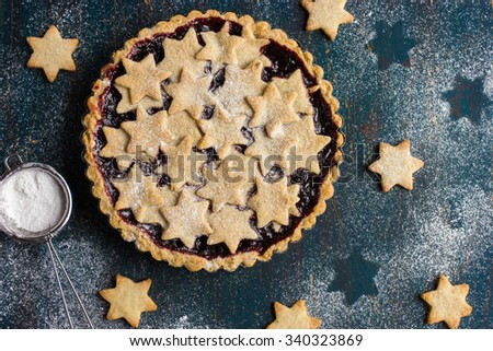 tart with berries jam and cookies, top view