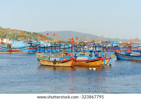 several Fishing boats with red flags in marina at Nha Trang, Vietnam