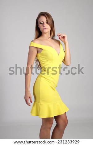 https://thumb7.shutterstock.com/display_pic_with_logo/2588176/231233929/stock-photo-beautiful-woman-in-yellow-dress-231233929.jpg