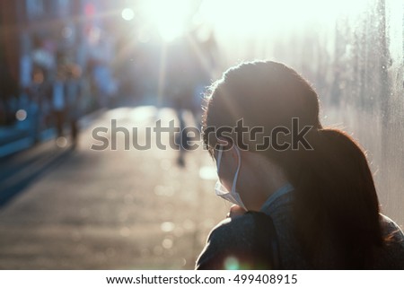 Woman with a mask coughing