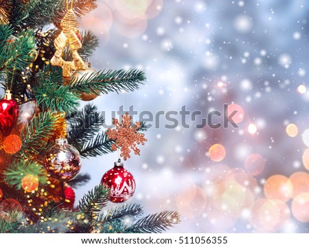 Christmas tree background and Christmas decorations with snow, blurred, sparking, glowing. Happy New Year and Xmas theme