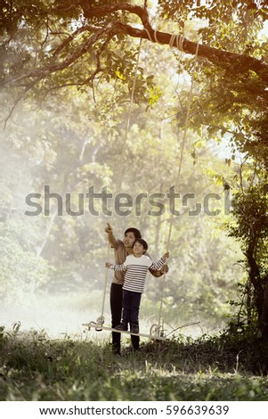 Vintage color photo happy joyful father having fun and son, family, travel, father's day - concept. Sunlight