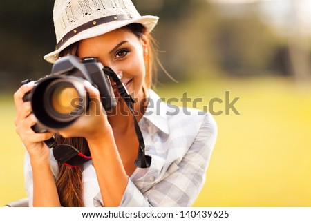attractive young woman talking pictures outdoors