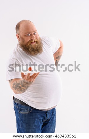 stock-photo-happy-fat-man-is-dieting-with-joy-he-is-holding-plate-with-small-tomato-and-posing-with-469433561.jpg