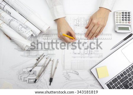 Architect working on blueprint. Architects workplace - architectural project, blueprints, ruler, calculator, laptop and divider compass. Construction concept. Engineering tools. Top view