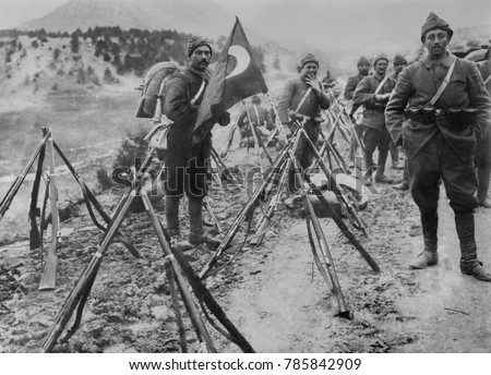 Turkish infantry column at rest with flag and rifles during World War I.