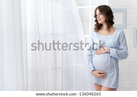 Portrait of the young pregnant woman