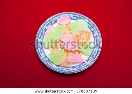 Vietnamese food for Tet holiday in spring, jam is traditional food on lunar new year, can make from sweet potato, lotus seed, ginger with sugar, colorful background for Vietnam custom