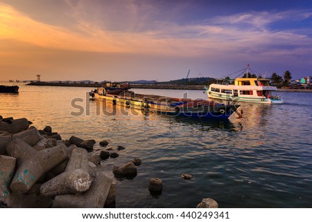 Phu Quoc island, Kien Giang province, Vietnam - May 02, 2016: amazing sunset at breakwater pier on Phu Quoc island . scene the boats were operating on the river to prepare to the sea in the sunset