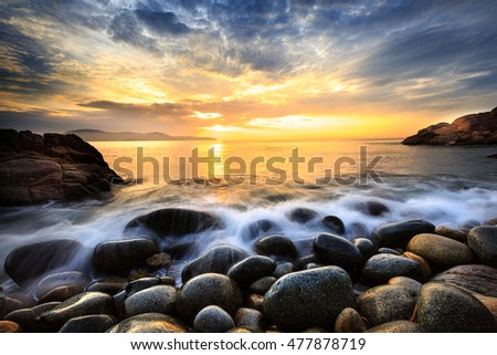 Long exposure of sea and stones, beautiful sunrise in Quy Nhon city, Vietnam