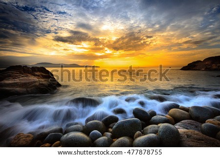 Long exposure of sea and stones, beautiful sunrise in Quy Nhon city, Vietnam
