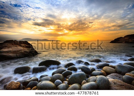 Long exposure of sea and stones, beautiful sunrise in Quy Nhon city, Vietnam