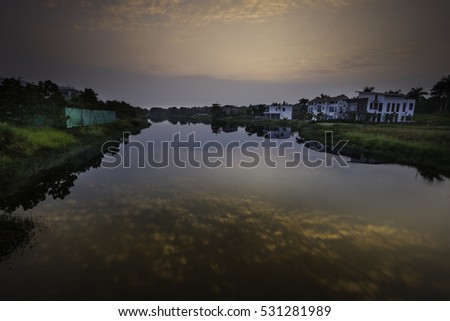 Flamingo Dai Lai, Vinh Phuc province, Vietnam - October 11, 2016 : calm lake reflection at sunset at Flamingo Dai Lai resort of Vinh Phuc Province, Vietnam
