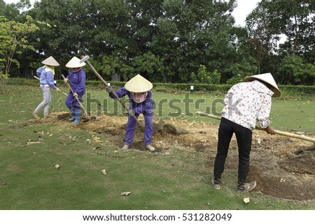 Flamingo Dai Lai, Vinh Phuc province, Vietnam - October 13, 2016 : The female workers who are working with the rudimentary tools at Flamingo Dai Lai resort of Vinh Phuc Province, Vietnam