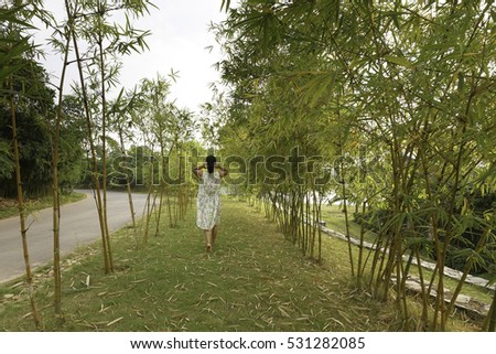 Flamingo Dai Lai, Vinh Phuc province, Vietnam - October 13, 2016 :woman relaxing walk in the bamboo forest at Flamingo resort Dai Lai, Vietnam