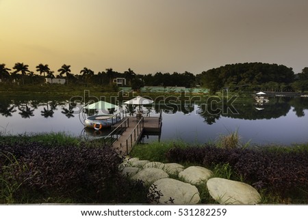 Flamingo Dai Lai, Vinh Phuc province, Vietnam - October 13, 2016 : walking path by stones to the pier on lake in Flamingo resort with dramatic sky at Flamingo Dai Lai resort of Vinh Phuc Province