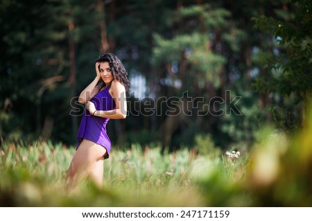 stock photo young fit brunette woman teasing with short dress on forest background in summer 247171159