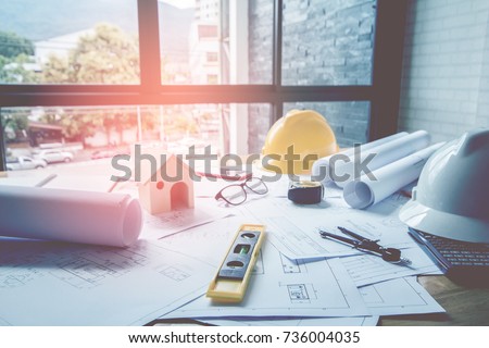 Concept architects, equipment architects On the desk with a blueprint in the office, Vintage, Sunset ligth.Selective Focus