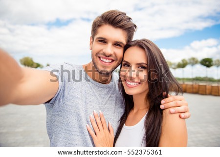 thumb7.shutterstock.com/display_pic_with_logo/2797510/552375361/stock-photo-loving-cheerful-happy-couple-taking-selfie-in-the-city-552375361.jpg