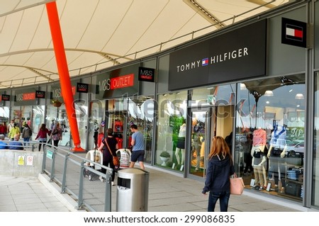 London, UK - June 14, 2015: Detail of the entrance to a Tommy Hilfiger store. Tommy Hilfiger is a famous American fashion designer for men, women and children apparel, sportswear, etc.