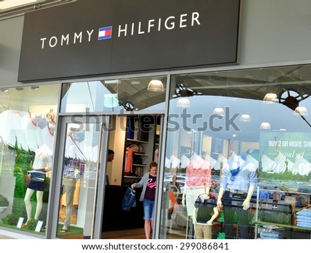London, UK - June 14, 2015: Detail of the entrance to a Tommy Hilfiger store. Tommy Hilfiger is a famous American fashion designer for men, women and children apparel, sportswear, etc.